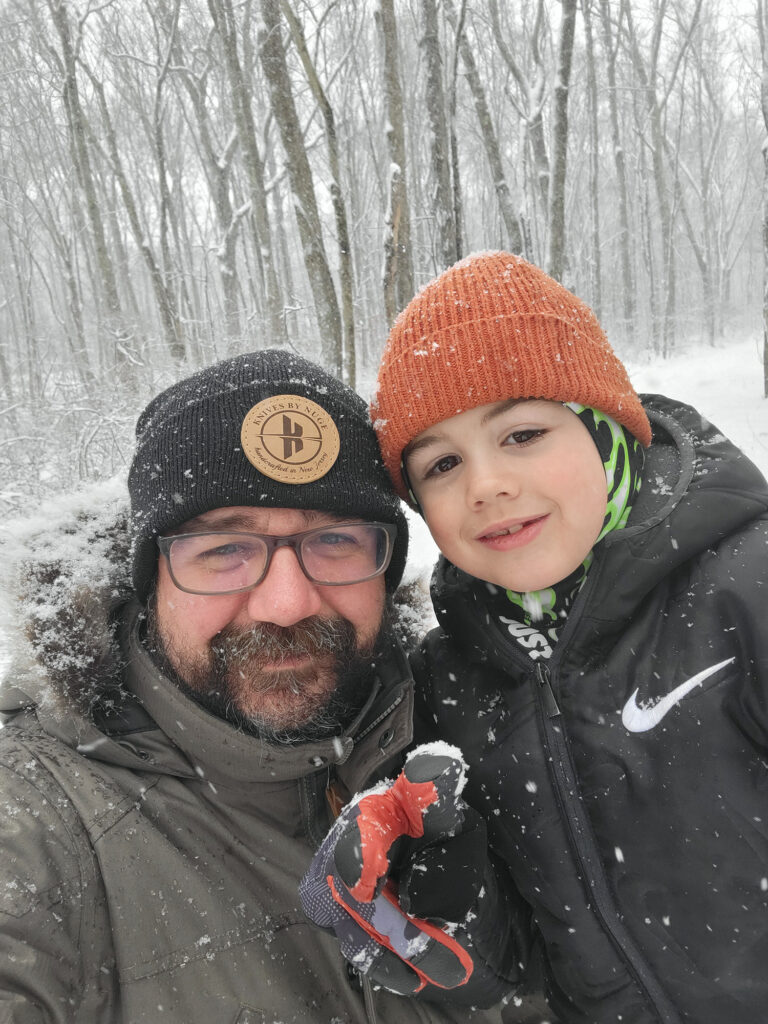 Nick Italiano in the snow with one of his children.